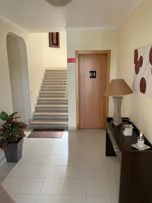a hallway with a staircase with a door and a lamp at Villa Roja Pé by Dream Villas Algarve in Albufeira