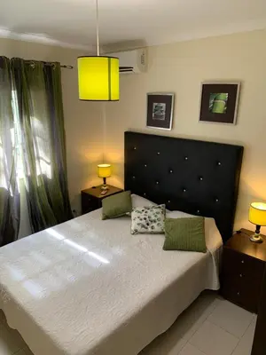 a bedroom with a large bed with two pillows on it at Villa Roja Pé by Dream Villas Algarve in Albufeira