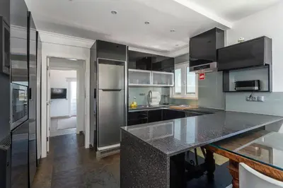 a kitchen with black and stainless steel appliances at Blife Charlya private apartment at Faro beach in Faro