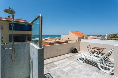 a balcony with a shower and a table and chairs at Blife Charlya private apartment at Faro beach in Faro