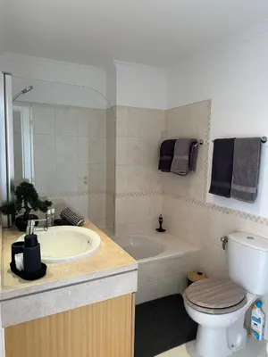 a bathroom with a tub and a toilet and a sink at Luz do Mar in Olhos de Água