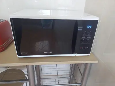 a microwave sitting on top of a table at Villa Duarte in Albufeira