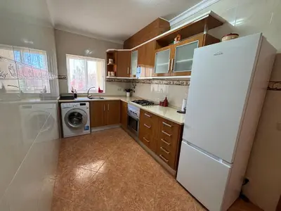 a kitchen with a white refrigerator and a dishwasher at Villa Duarte in Albufeira