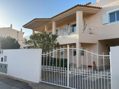 a white fence in front of a house at Villa Duarte in Albufeira