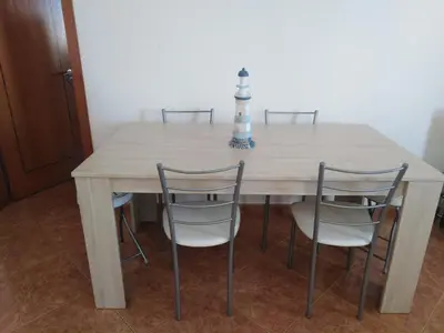 a dining room table with four chairs around it at Villa Duarte in Albufeira