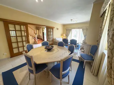 a dining room with a table and chairs at Palm Villa in Albufeira
