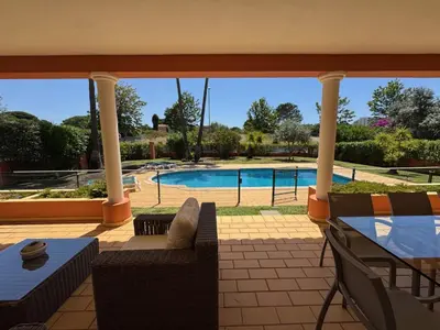 a patio with a view of a swimming pool at Palm Villa in Albufeira