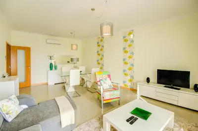 a living room with a couch and a table at Encosta Da Orada Vista Mar in Albufeira