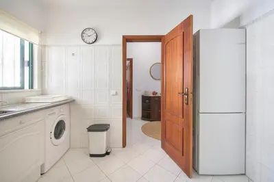 a kitchen with a refrigerator and a sink at 2 Bedroom by Quarteira Beach in Quarteira