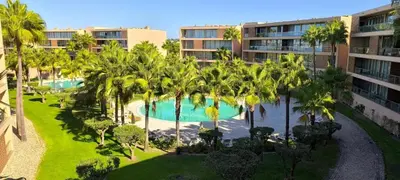 an aerial view of a resort with a pool and palm trees at Herdade dos Salgados in Guia