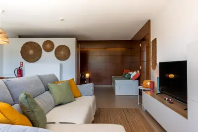 a living room with a couch and a television at Herdade dos Salgados in Guia