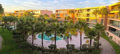 an aerial view of a resort with a pool and palm trees at Herdade dos Salgados in Guia