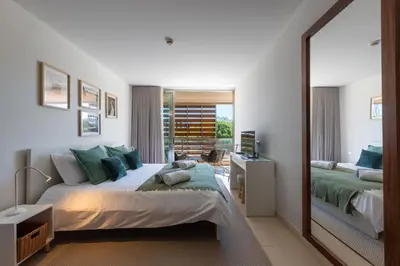 a bedroom with two beds and a large mirror at Herdade dos Salgados in Guia