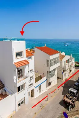 a kitchen and living room with a couch and a table at Sandora Pearl By Seareen, Penthouse with sea view in Albufeira