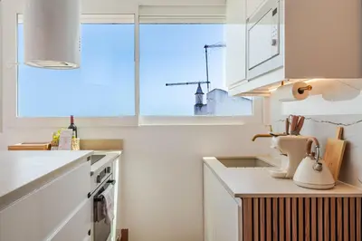 a white bed with towels on it next to a window at Sandora Pearl By Seareen, Penthouse with sea view in Albufeira