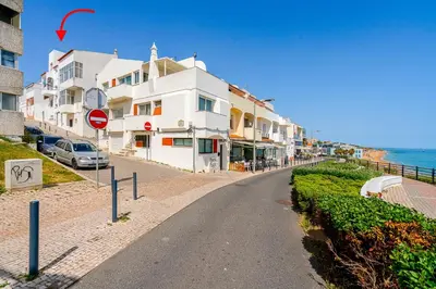 a dining room with a table with plates and chairs at Sandora Pearl By Seareen, Penthouse with sea view in Albufeira