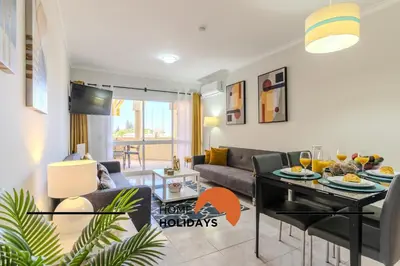 a living room with a couch and a table at #283 Palmeira Gale by Home Holidays in Galé