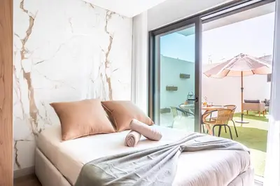 a bedroom with a bed with a view of a patio at Downtown Luxury Studio - Faro in Faro