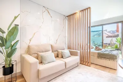 a living room with a couch and a bed at Downtown Luxury Studio - Faro in Faro