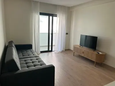an empty room with white walls and a wooden floor at Casa aOrta Apartments in Faro