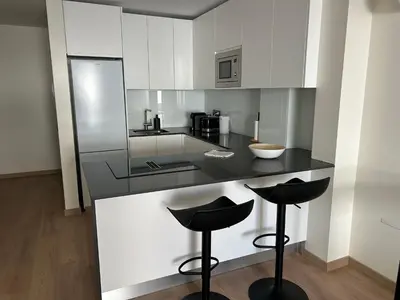 a living room with a table and chairs and a couch at Casa aOrta Apartments in Faro