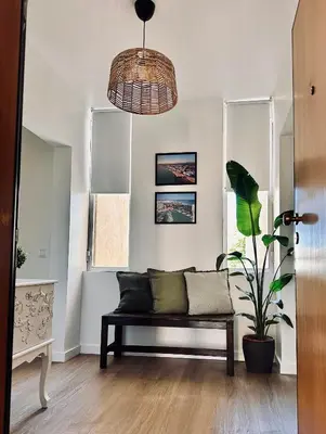 a living room with a bench and a potted plant at Vilamoura Living 106 in Quarteira