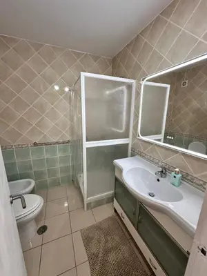 a bathroom with a sink and a toilet and a shower at Vilamoura Living 106 in Quarteira