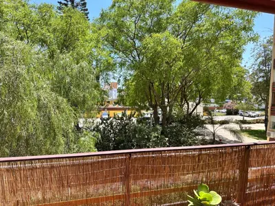 a fence in front of a yard with trees at Vilamoura Living 106 in Quarteira