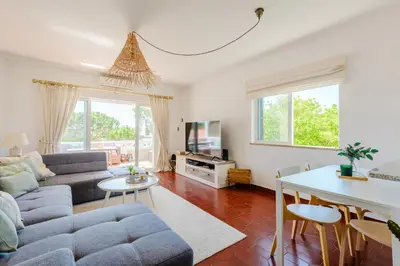 a living room with a couch and a table at Vale do Lobo Apartment D in Vale do Lobo