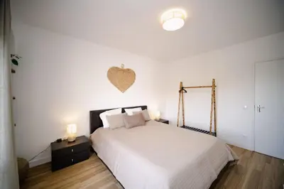 a bedroom with a bed with a heart on the wall at Apartamento JADA in Albufeira