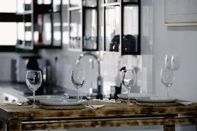 three wine glasses sitting on a table in a kitchen at Apartamento JADA in Albufeira