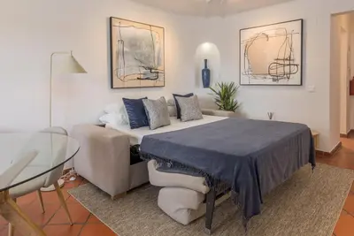 a bedroom with a bed and a glass table at Albufeira Club 109 in Albufeira