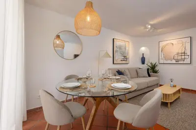a living room with a table and chairs and a couch at Albufeira Club 109 in Albufeira