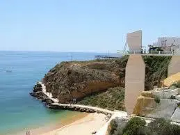 an island in the ocean next to a body of water at Apartament Encosta Da Orada in Albufeira