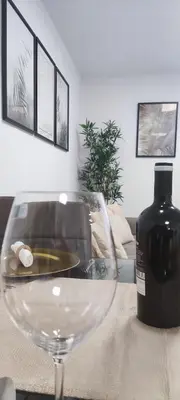 a glass table with a bottle of wine on a couch at Albufeira New House in Albufeira