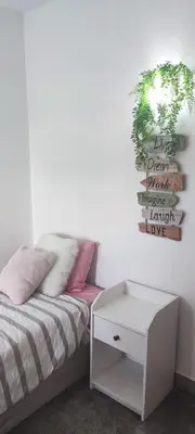 a bedroom with a bed and a plant on the wall at Albufeira New House in Albufeira
