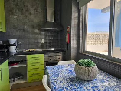 a kitchen with a table with a bowl on it at Blife Bandaya private rooms at Faro beach in Faro