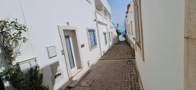 an alleyway between two buildings in a town at Manu's Place in Albufeira