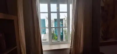 a window with a view of a building at Manu's Place in Albufeira