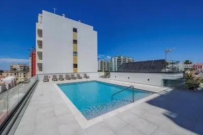 a swimming pool on the roof of a building at Terracos de Quarteira II Pearl by Real Properties in Quarteira