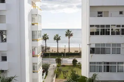 a view of the beach from between two buildings at Terracos de Quarteira I Aqua by Real Properties in Quarteira