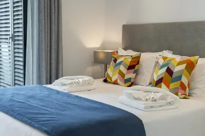 a bed with towels and pillows on top of it at Terraccos de Quarteira Silver by Real Properies in Quarteira