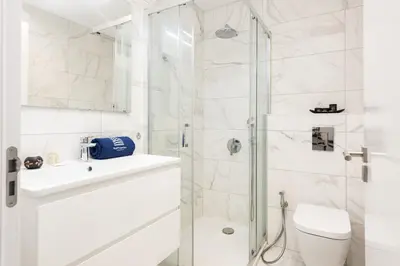 a bathroom with a shower and a toilet and a sink at Terraccos de Quarteira Silver by Real Properies in Quarteira