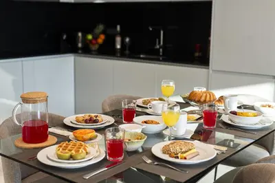 a table topped with plates of food and drinks at Terraccos de Quarteira Silver by Real Properies in Quarteira