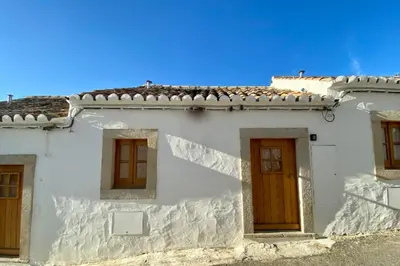 a white building with brown doors and windows at Laranjeira 1 by AlmaAlgarvia in Santa Bárbara de Nexe