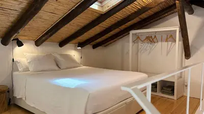 a living room with a white couch and a flat screen tv at Laranjeira 1 by AlmaAlgarvia in Santa Bárbara de Nexe