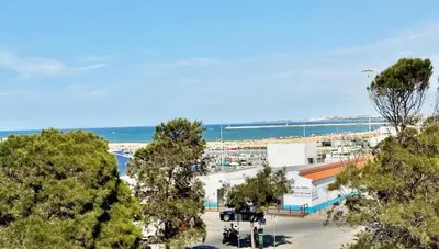 an aerial view of a parking lot at a beach at Casa do Largo - Quarteira Algarve in Quarteira