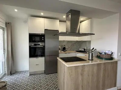 a kitchen with stainless steel appliances and a counter at Âncora Mar by FHR in Quarteira
