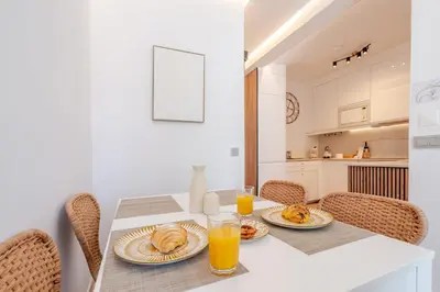 a white kitchen with white cabinets and a sink at Sandora Breeze by Seareen in Albufeira