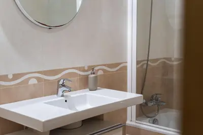 a bathroom with a sink and a mirror and a shower at Praia Village III - Peaceful condominium by HD in Quarteira